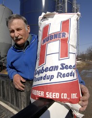 Photo by Skip Lawrence - Gareth Harshman displays a bag of Roundup Ready soybean seeds at his farm near New Market.
